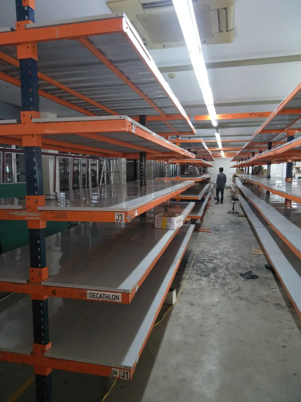 Cantilever-style shelving with steel decks installed in a textile company warehouse
